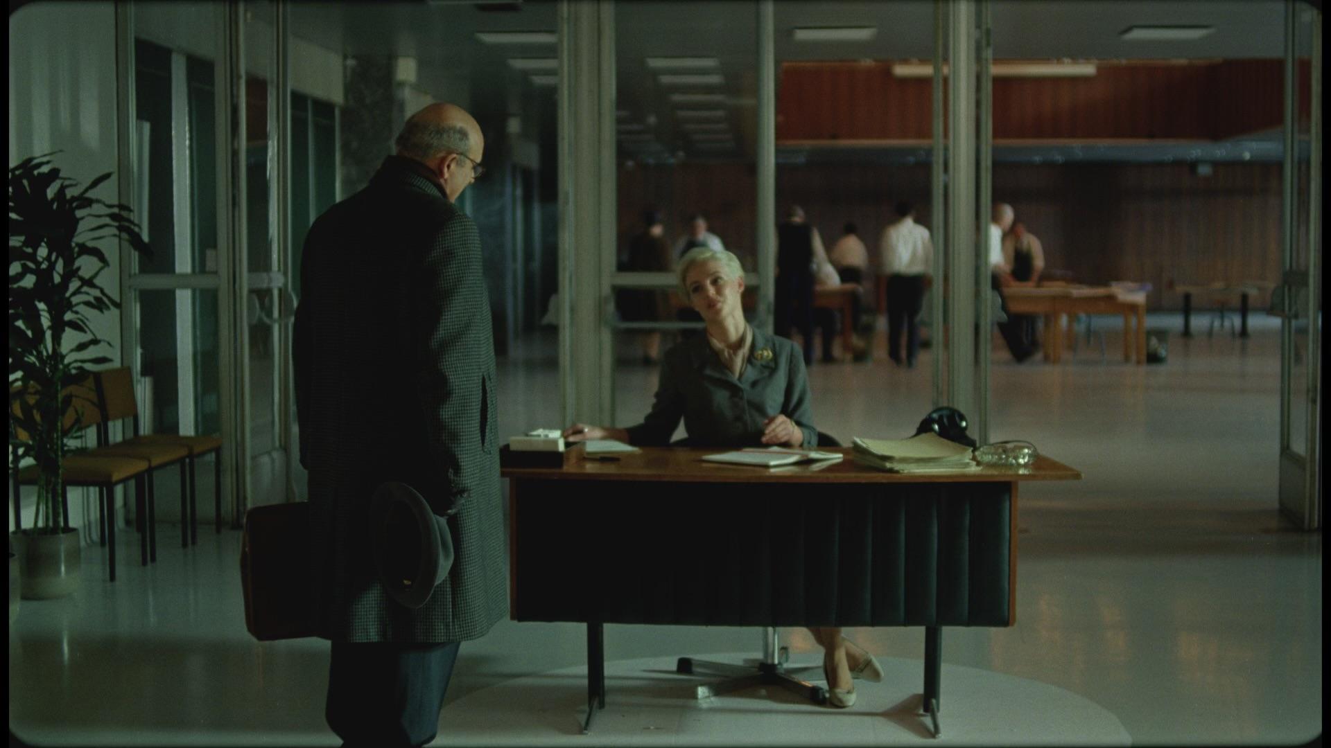 Hoffman asks for directions to where Toth is working within the building